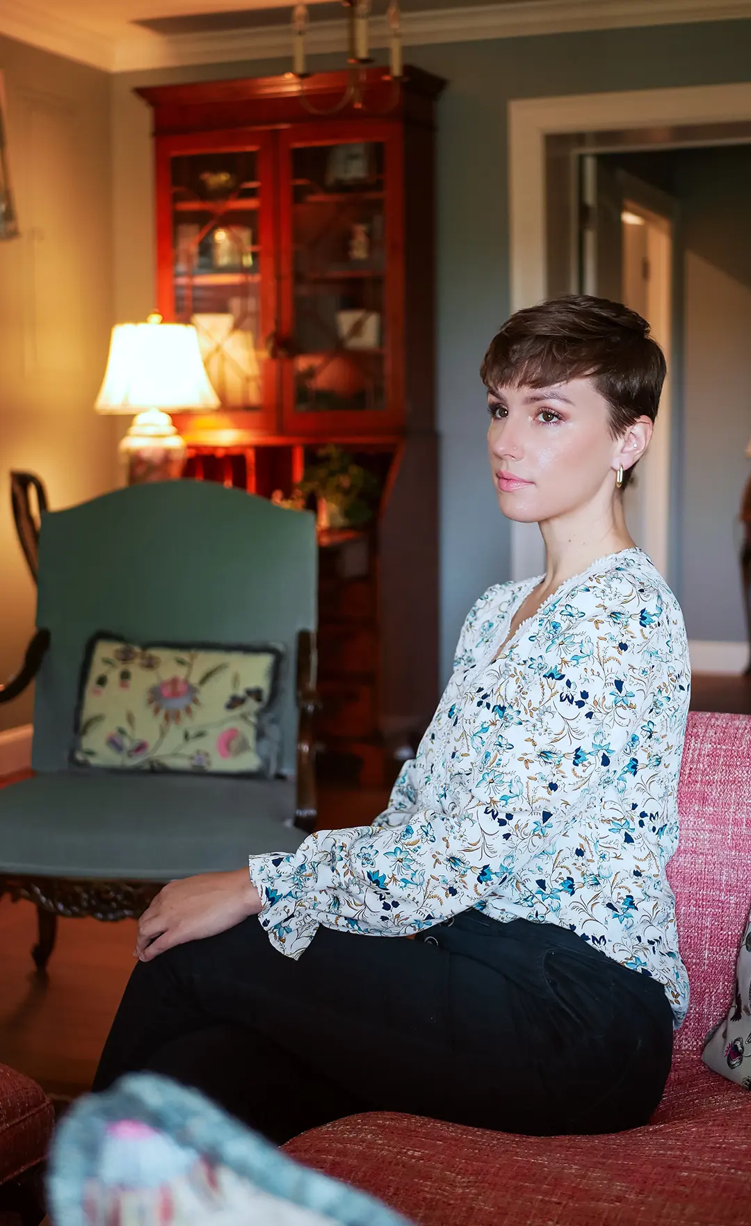 Madeline Diane seated in a warm, lived-in room